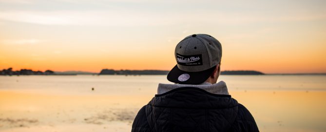man looking at sunrise